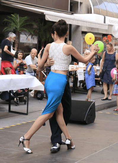 Tango dancing in the street sidewalk tango