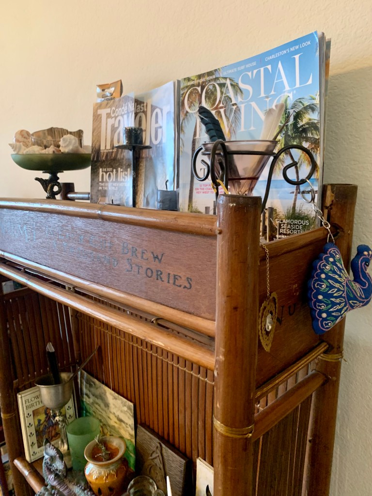A bamboo shelf case holds travel magazines and natural items
