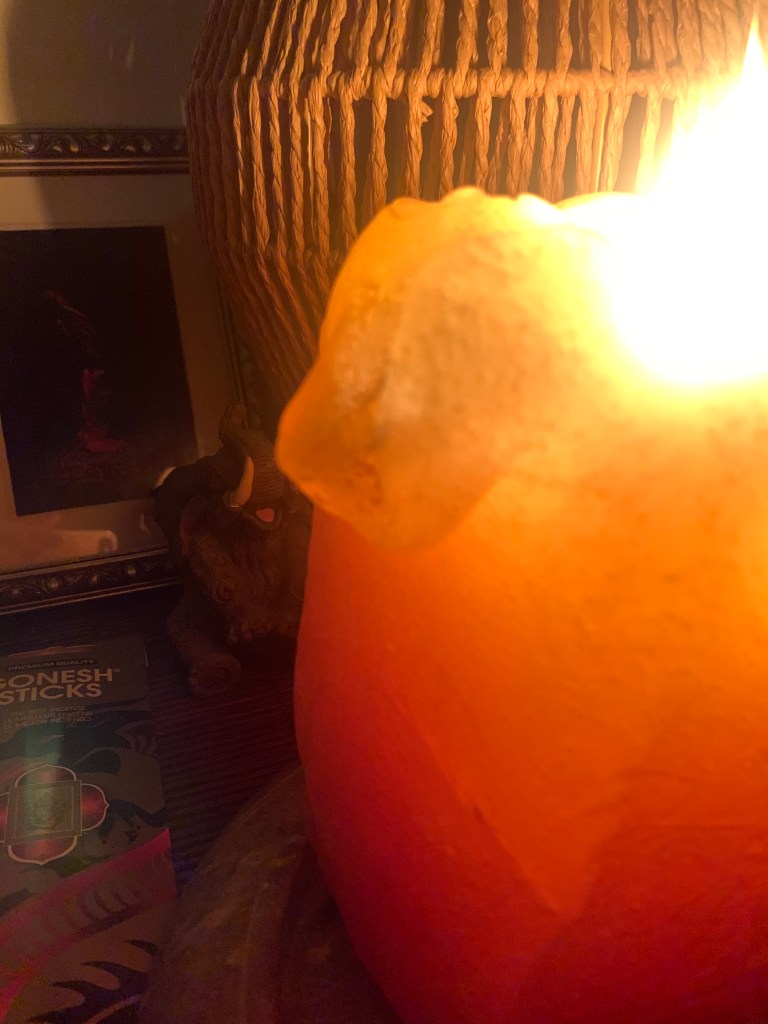 The warm glow from a mango candle and lamp made with natural material.