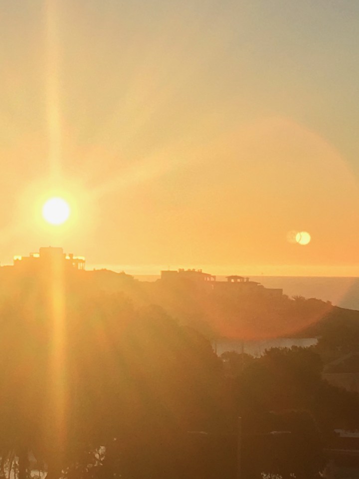 The bright, warm and golden moring sun rises off the coast of Mallorca.